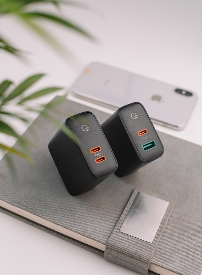 about-us-01 From above of power banks with notebook and modern mobile phone placed on white table